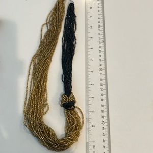 Gold and black necklace arranged in a unique way from Murano glass beads